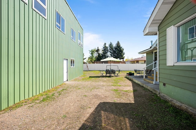 view of yard featuring fence and entry steps