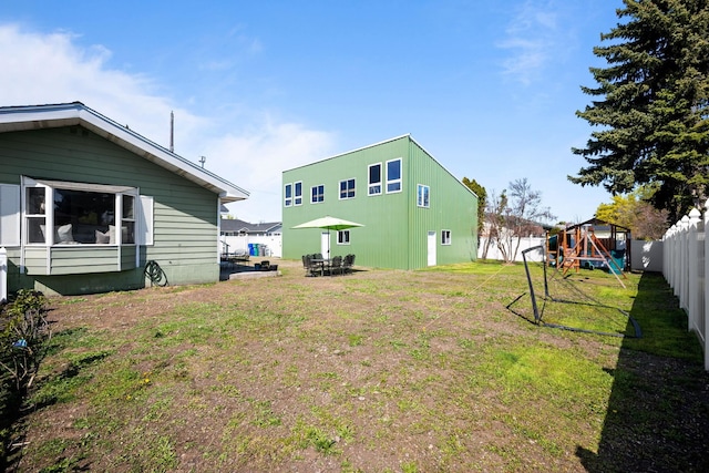 view of yard featuring a playground and a fenced backyard