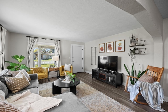 living room featuring wood finished floors and baseboards