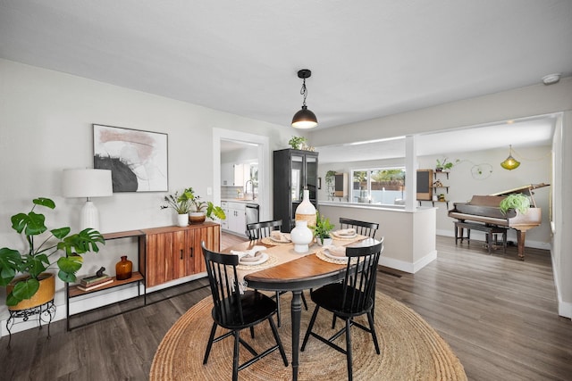 dining area featuring wood finished floors and baseboards