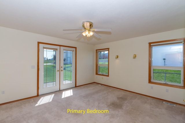 unfurnished room with a ceiling fan, french doors, light carpet, and baseboards