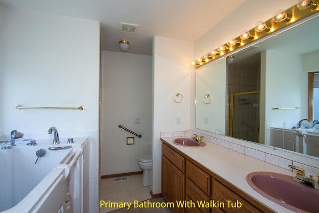 bathroom with visible vents, a garden tub, and a sink