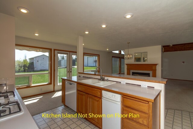 kitchen with a sink, open floor plan, dishwasher, light carpet, and french doors