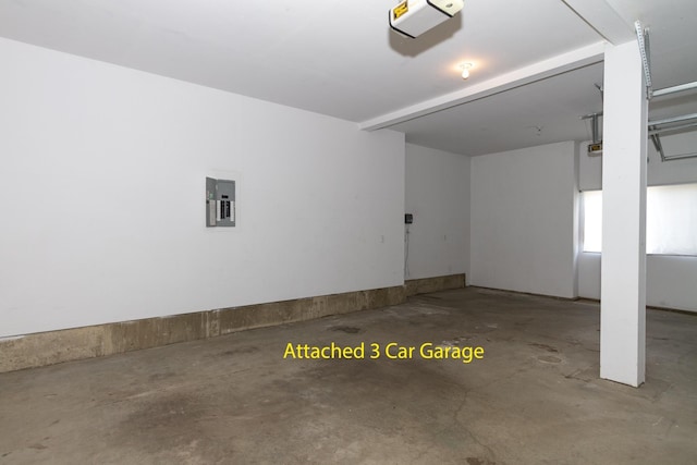 garage featuring electric panel and a garage door opener