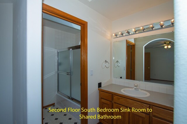 bathroom with a ceiling fan, an enclosed shower, and vanity