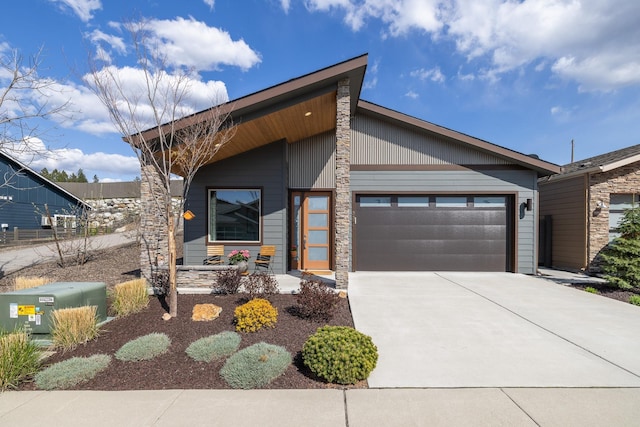 3306 N Ladalia Dr, Coeur D Alene, ID 83814 - contemporary house with concrete driveway, stone siding, and a garage