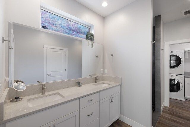 3306 N Ladalia Dr, Coeur D Alene, ID 83814 - full bath with visible vents, stacked washing maching and dryer, wood finished floors, and a sink