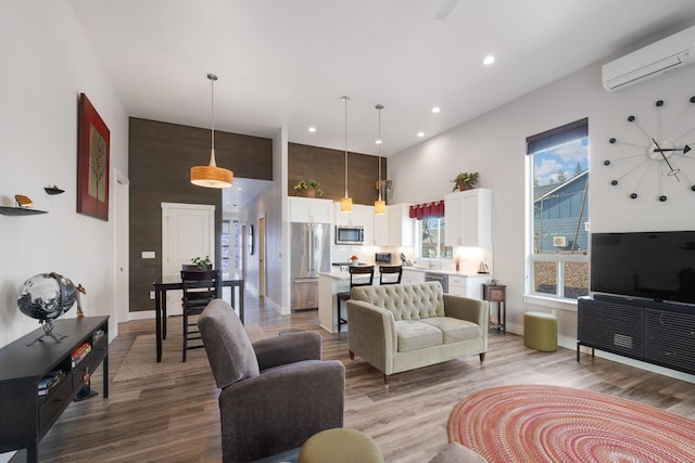 3306 N Ladalia Dr, Coeur D Alene, ID 83814 - living area with baseboards, recessed lighting, wood finished floors, and an AC wall unit