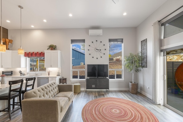 3306 N Ladalia Dr, Coeur D Alene, ID 83814 - living room featuring a wall mounted air conditioner, light wood finished floors, recessed lighting, and a toaster