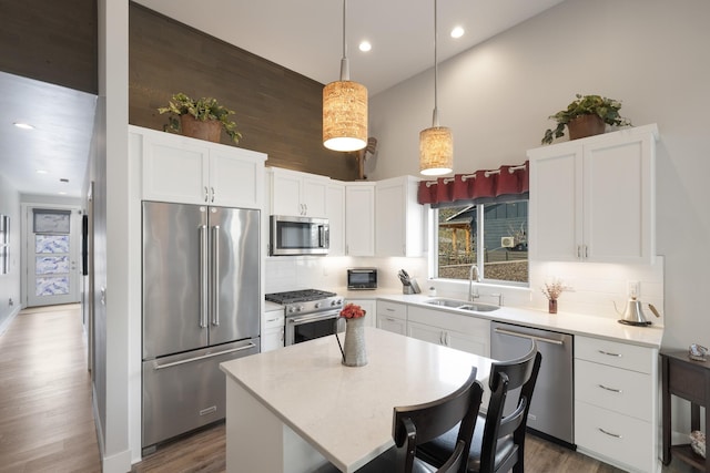 3306 N Ladalia Dr, Coeur D Alene, ID 83814 - kitchen featuring white cabinetry, tasteful backsplash, a sink, light countertops, and high quality appliances