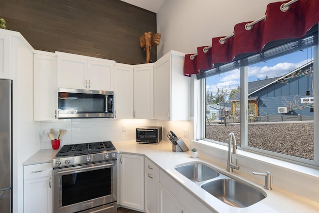 3306 N Ladalia Dr, Coeur D Alene, ID 83814 - kitchen with appliances with stainless steel finishes, tasteful backsplash, white cabinets, and a sink