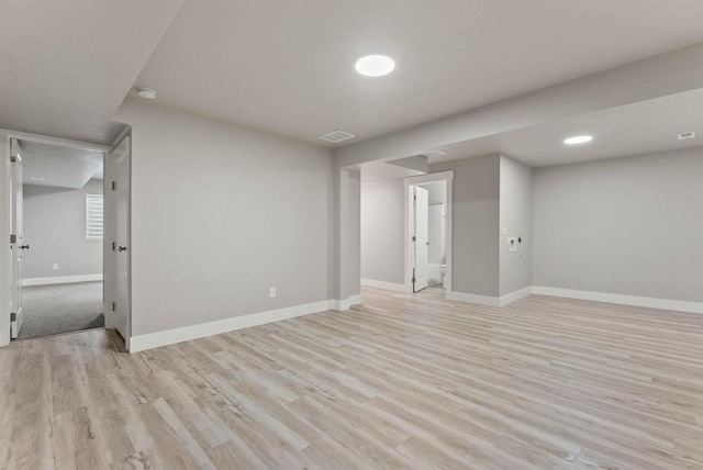interior space featuring light wood finished floors, visible vents, and baseboards