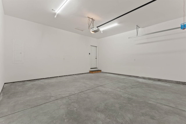 garage featuring electric panel and a garage door opener