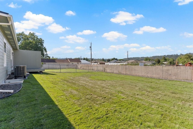 view of yard with a fenced backyard and central air condition unit