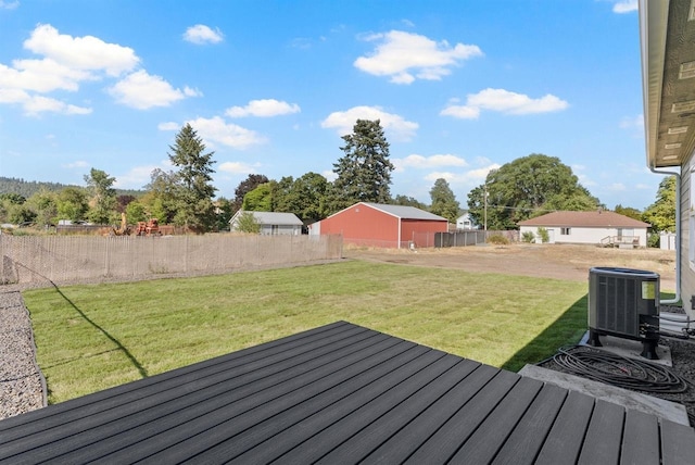 wooden terrace featuring cooling unit, a lawn, and fence