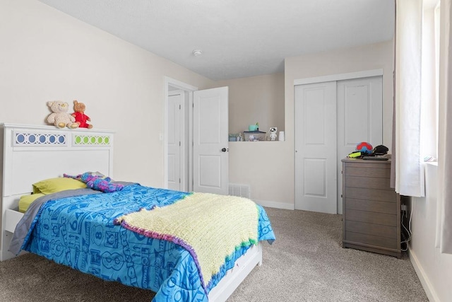 carpeted bedroom with baseboards, visible vents, and a closet