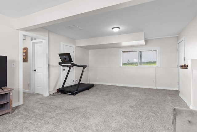 workout area featuring baseboards and carpet floors