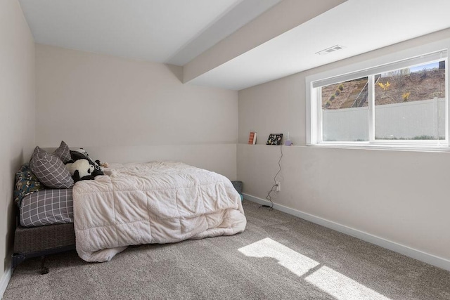 carpeted bedroom with visible vents and baseboards
