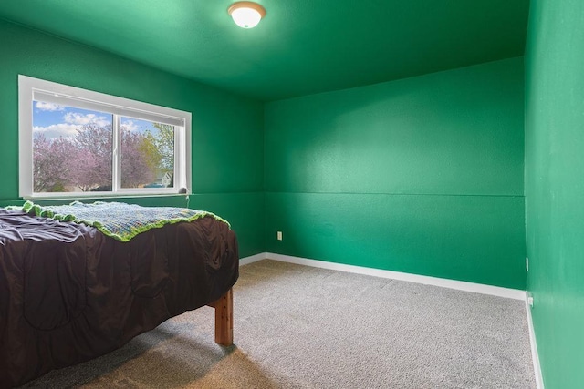 carpeted bedroom featuring baseboards