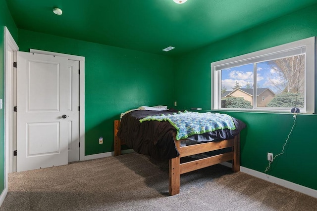 bedroom with visible vents, carpet floors, and baseboards