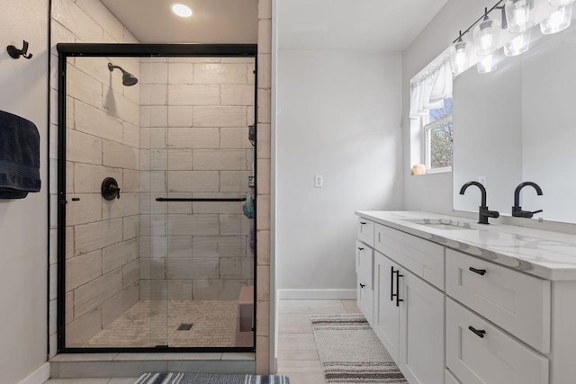 bathroom featuring recessed lighting, tile patterned floors, vanity, baseboards, and a stall shower