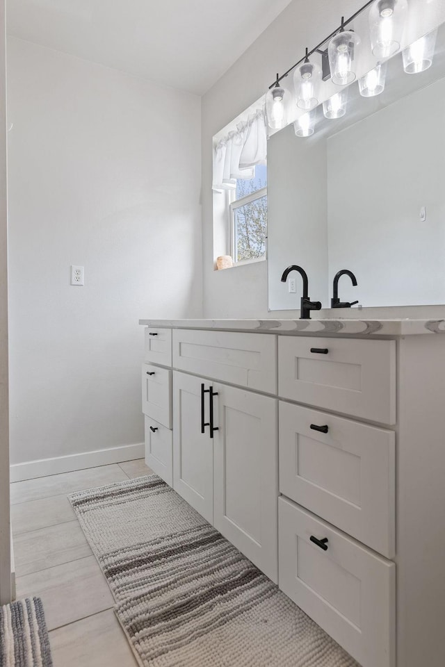 bathroom with vanity and baseboards
