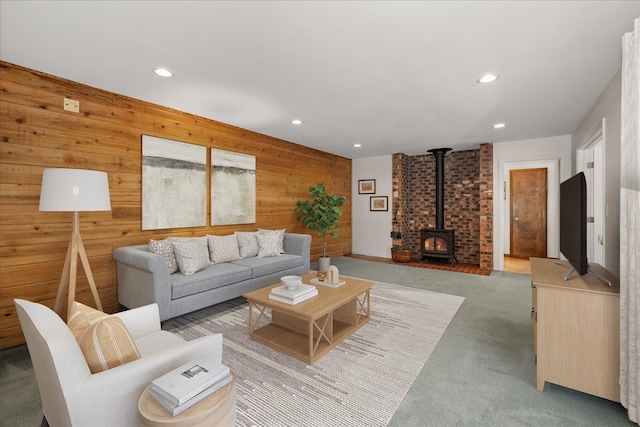 2711 S Pittsburg St, Spokane, WA 99203 - living room with a wood stove, recessed lighting, wooden walls, and light colored carpet