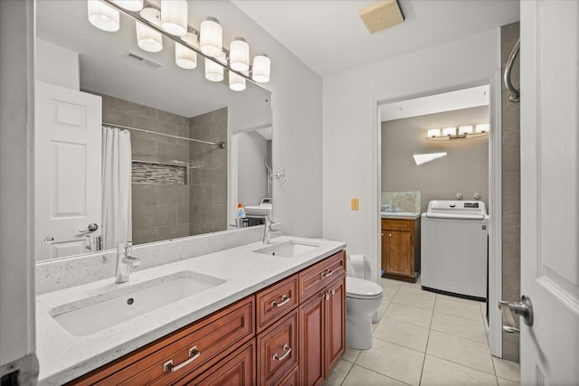 2711 S Pittsburg St, Spokane, WA 99203 - bathroom with washer / dryer, tile patterned floors, toilet, double vanity, and tiled shower