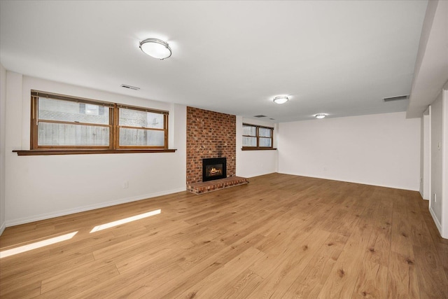 2711 S Pittsburg St, Spokane, WA 99203 - unfurnished living room featuring light wood finished floors, a fireplace, and baseboards