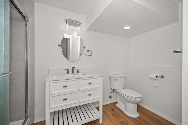 2711 S Pittsburg St, Spokane, WA 99203 - full bathroom with toilet, wood finished floors, a stall shower, vanity, and baseboards