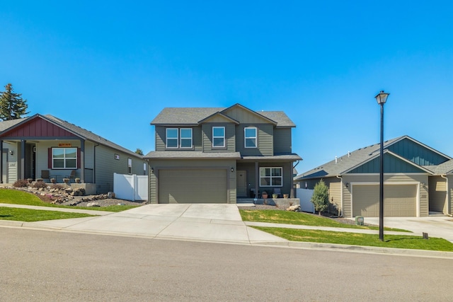 craftsman house featuring concrete driveway, board and batten siding, covered porch, an attached garage, and fence