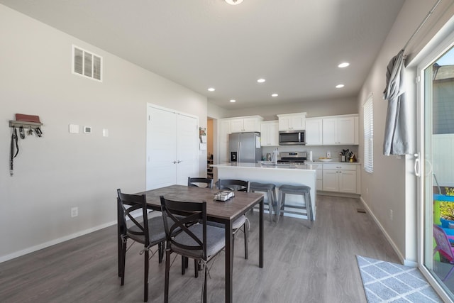 dining area with visible vents, recessed lighting, light wood finished floors, and baseboards