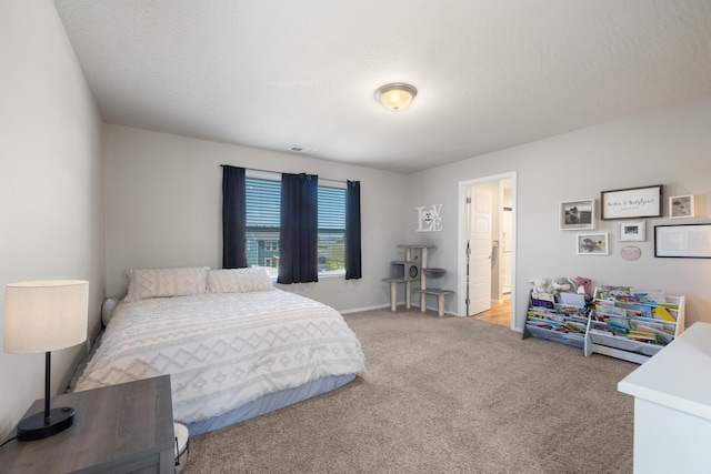 bedroom with baseboards, visible vents, and light colored carpet