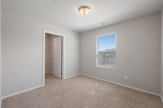 1102 S Best Rd, Spokane Valley, WA 99037 - unfurnished bedroom featuring light carpet, a walk in closet, and a closet