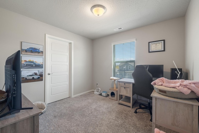 carpeted office space featuring baseboards and visible vents