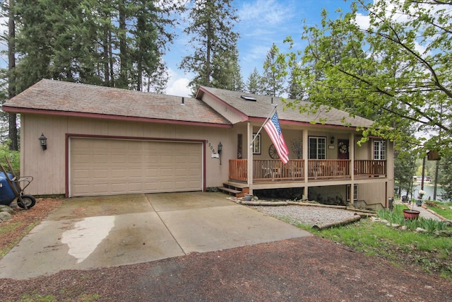 9306 E Lake Rd, Elk, WA 99009 - ranch-style home featuring covered porch, an attached garage, and driveway