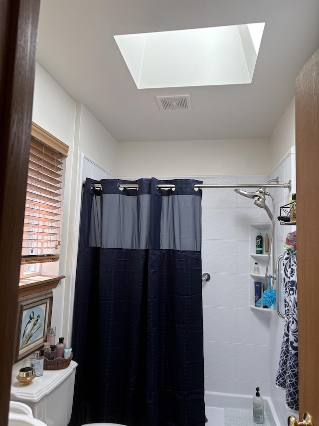 9306 E Lake Rd, Elk, WA 99009 - bathroom with visible vents, a tile shower, a skylight, and toilet