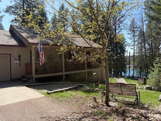 9306 E Lake Rd, Elk, WA 99009 - exterior space with concrete driveway, a porch, and a garage
