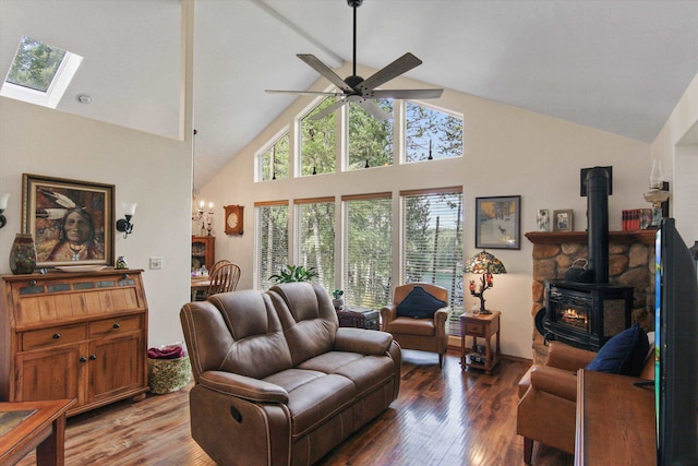 9306 E Lake Rd, Elk, WA 99009 - living area featuring wood-type flooring, a wood stove, ceiling fan with notable chandelier, and high vaulted ceiling