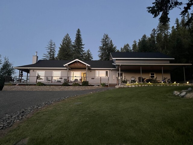 view of front facade featuring a front lawn and a chimney