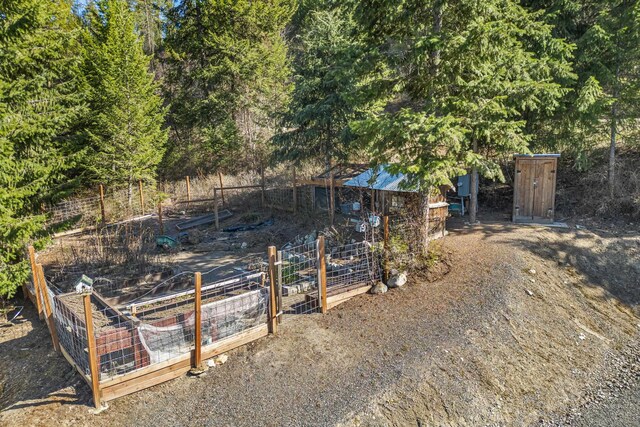 view of yard featuring fence and a garden