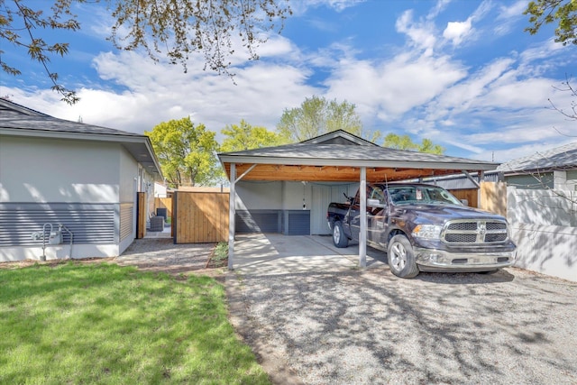 exterior space featuring a front lawn, a carport, and fence