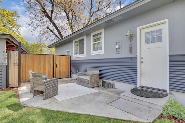 property entrance featuring a patio area and fence