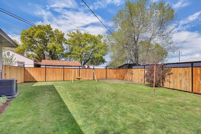 view of yard with a fenced backyard and central air condition unit