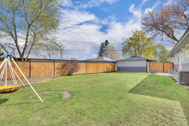 view of yard featuring central AC unit and a fenced backyard