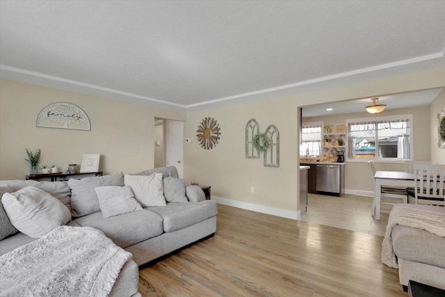 living area with light wood-type flooring and baseboards