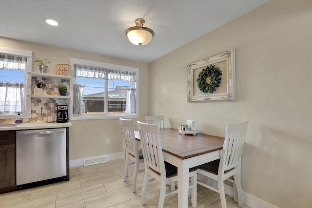 dining room with visible vents, a wealth of natural light, and baseboards