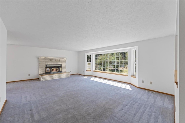 unfurnished living room featuring a brick fireplace, visible vents, carpet floors, and baseboards