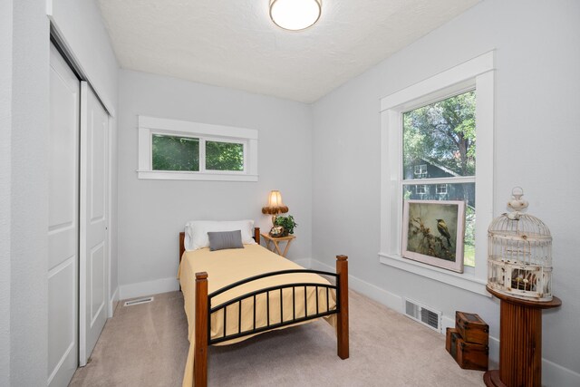 817 W Frederick Ave, Spokane, WA 99205 - carpeted bedroom with visible vents, multiple windows, and a closet