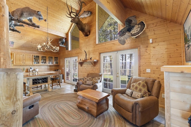 tiled living area with wooden walls, high vaulted ceiling, and french doors